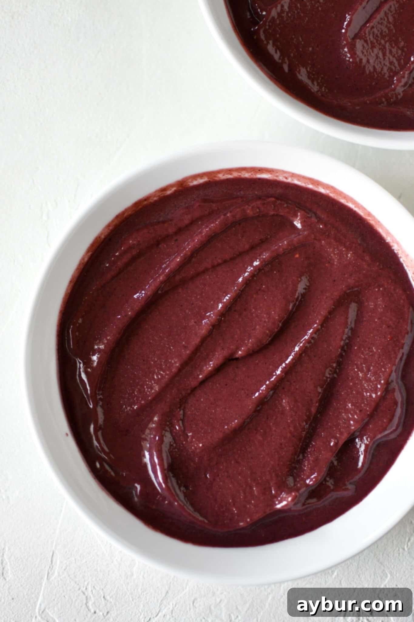 Laying the base of the smoothie bowl in the bottom of a large bowl.