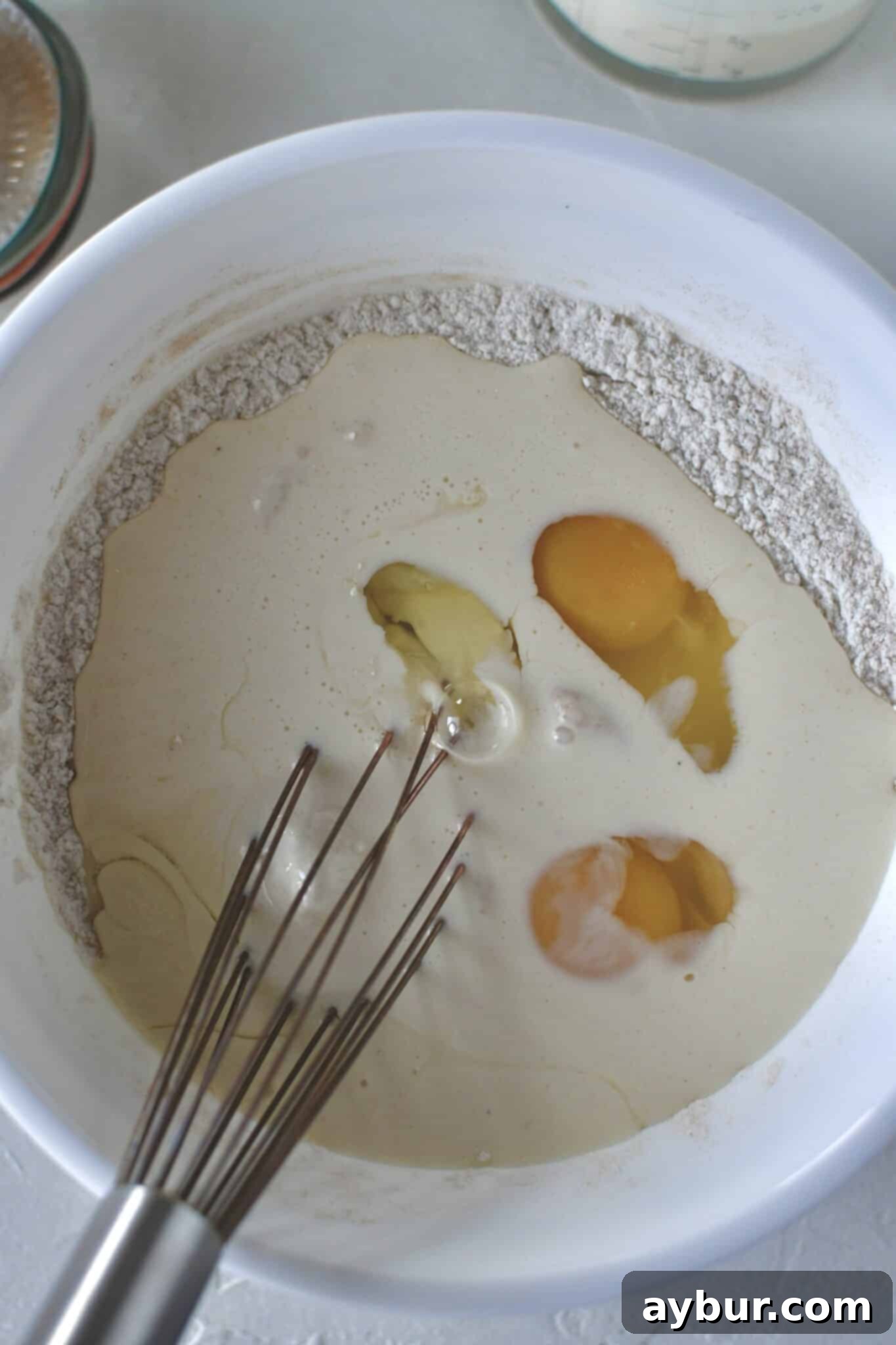 Festive Eggnog Pancakes 4 Mixing the dry ingredients for Eggnog Pancakes in a large bowl.