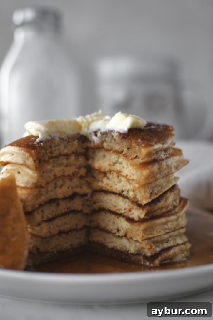 Festive Eggnog Pancakes 7 A close-up of a stack of golden brown Eggnog Pancakes, ready to be served.