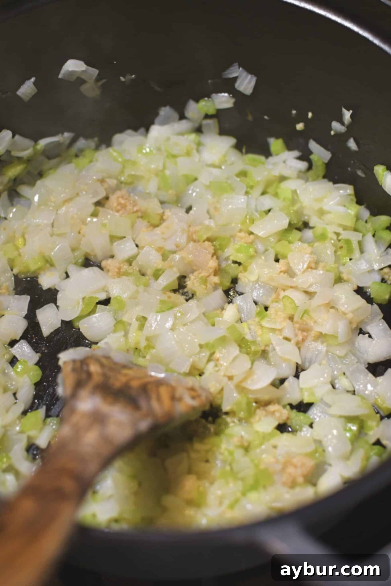 Sautéing diced onions and celery in a Dutch oven with butter and olive oil.