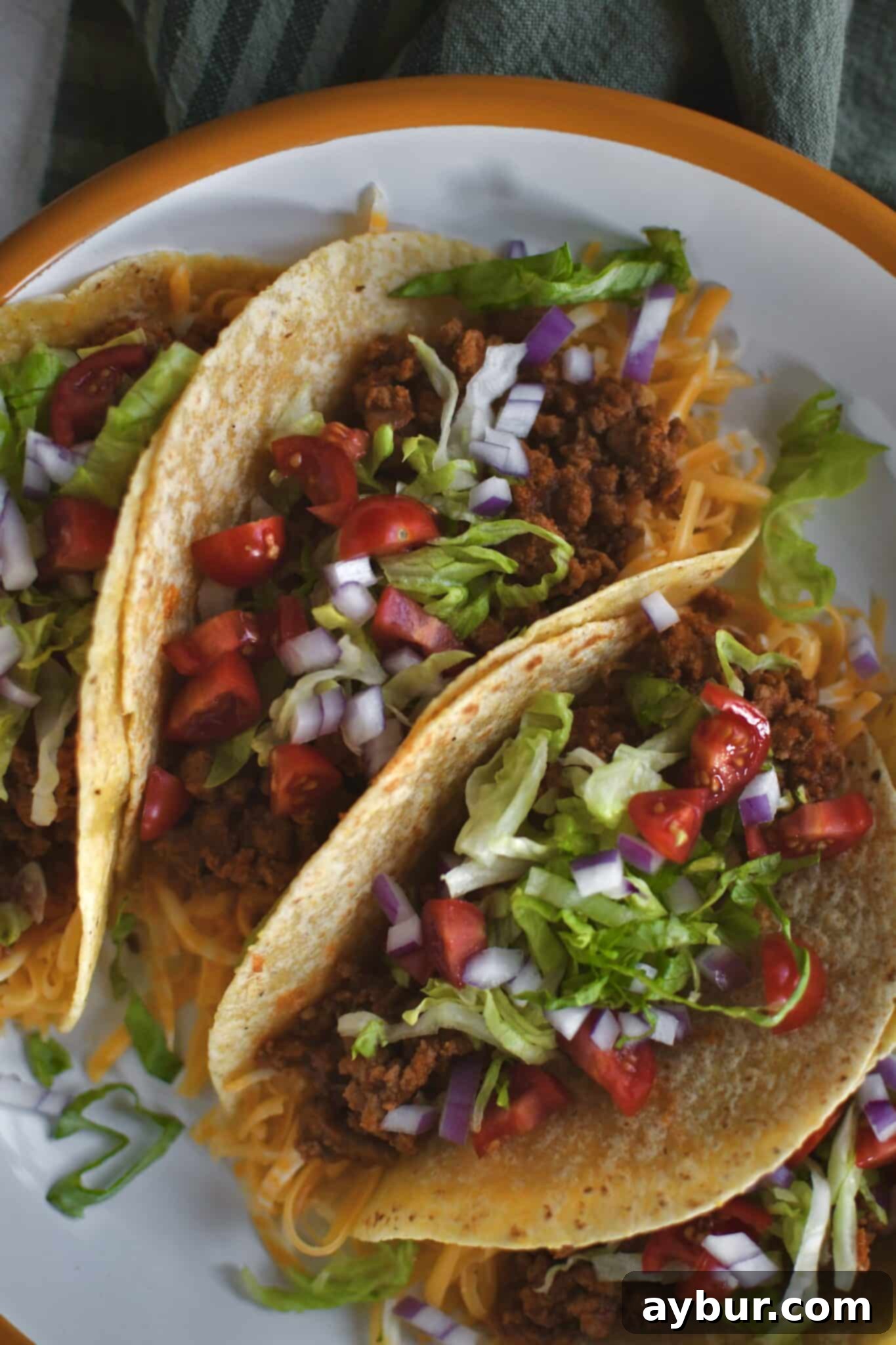 A close-up of a delicious Ground Turkey Taco, garnished with fresh and vibrant toppings, ready to be enjoyed.