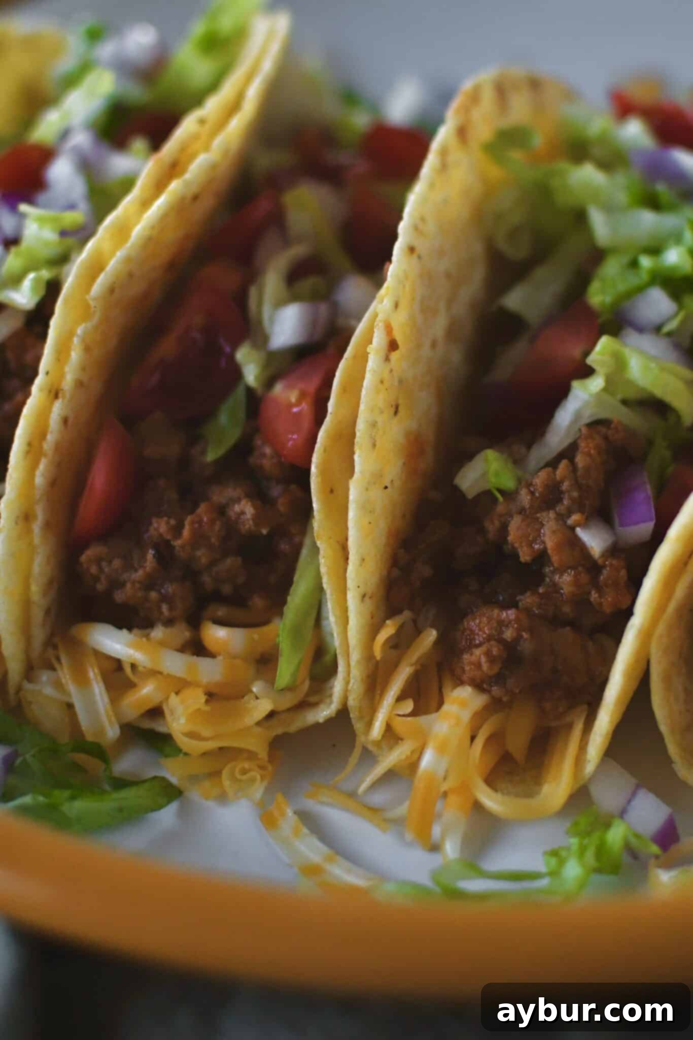 A vibrant and appealing spread of cooked Ground Turkey Tacos and a variety of colorful toppings, inviting to eat.