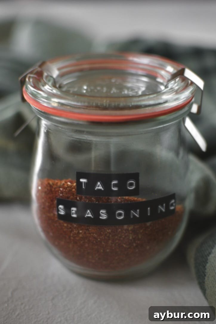 DIY Taco Spice Blend 2 Freshly mixed homemade taco seasoning in a clear glass jar, ready for use, emphasizing its vibrant colors and inviting texture.