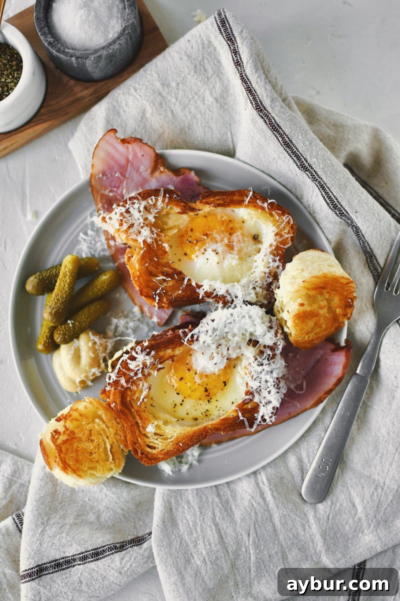 Eggy in a Basket served over a ham steak and topped with gruyere cheese.