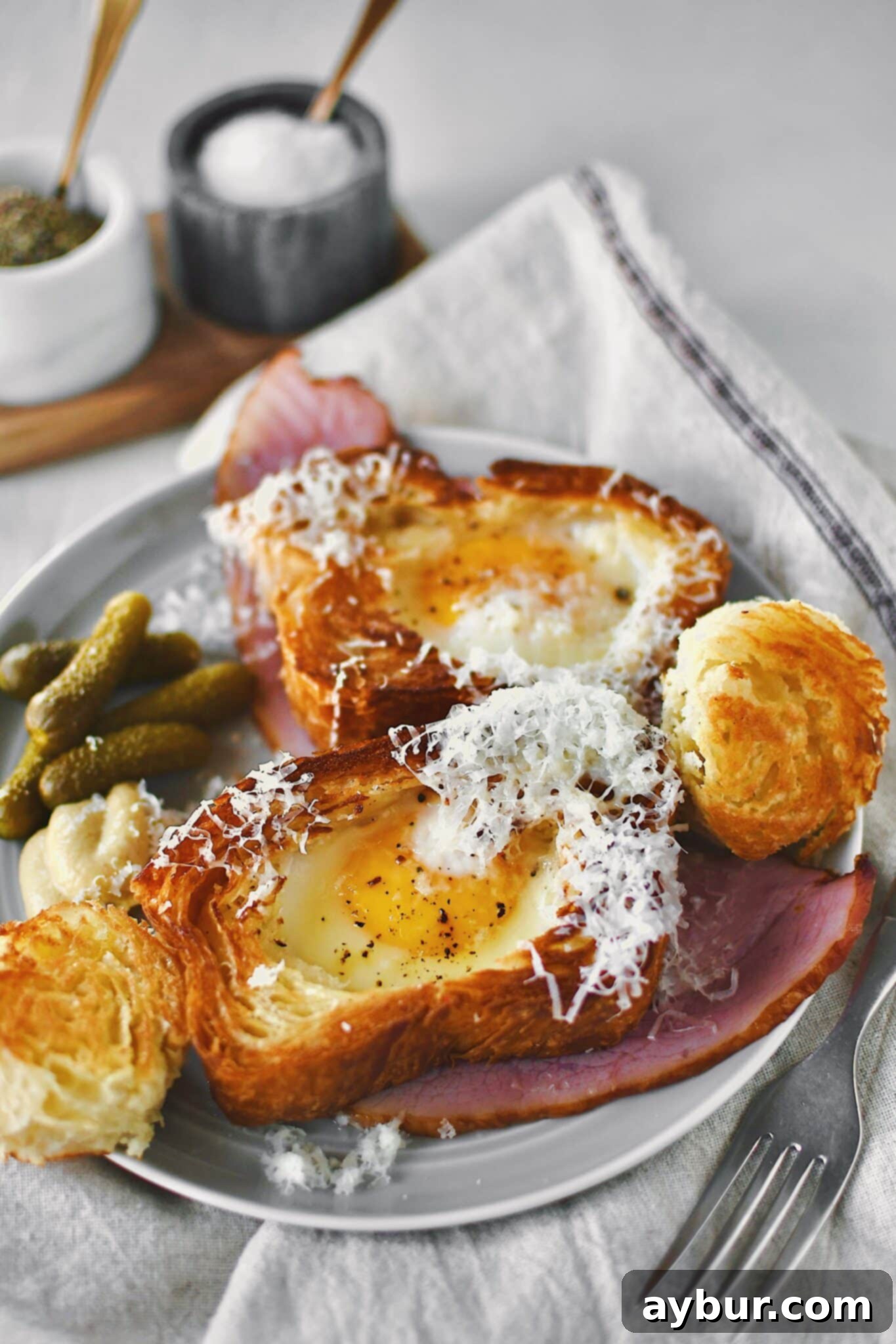 Egg in a Basket served over a ham steak and topped with gruyere cheese.