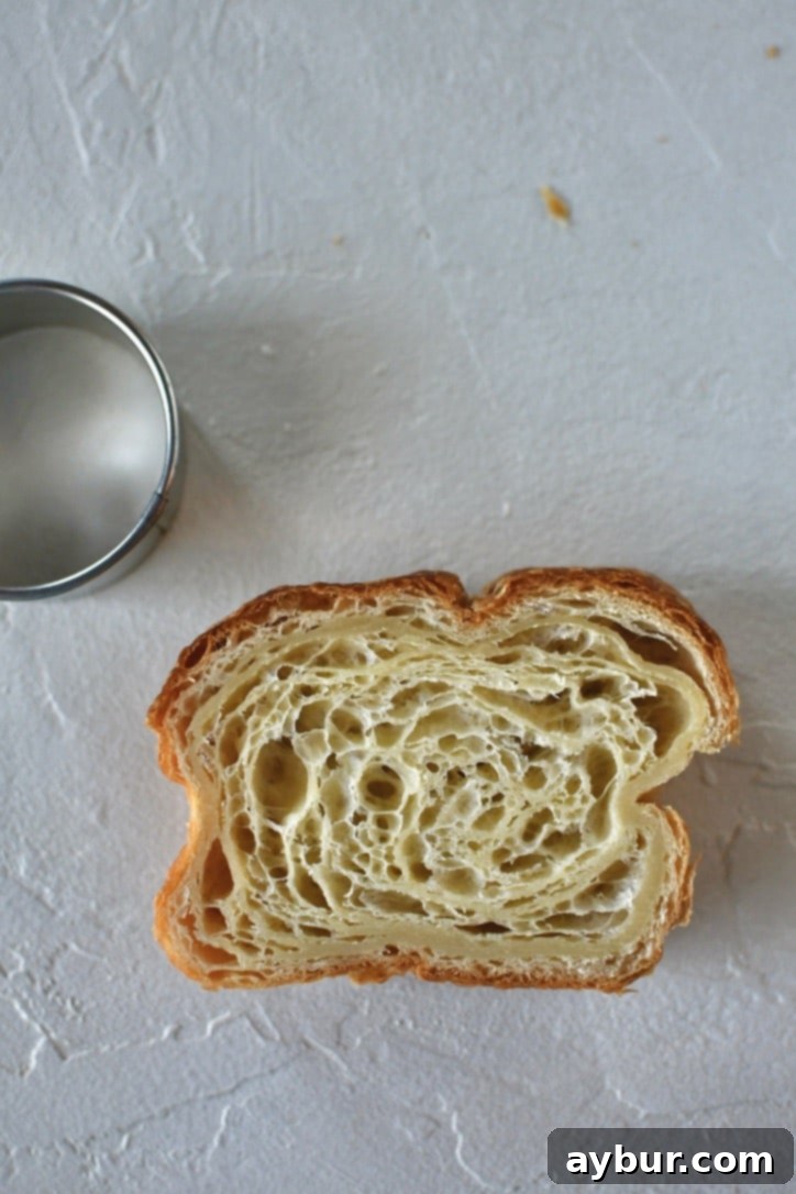 Croissant Toast on a work surface with a round cutter next to it.