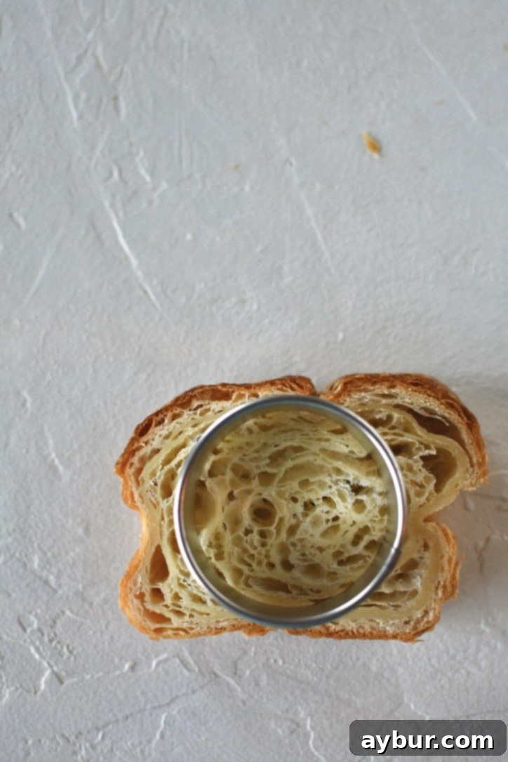 Croissant Toast on a work surface with a round cutter on top of it.