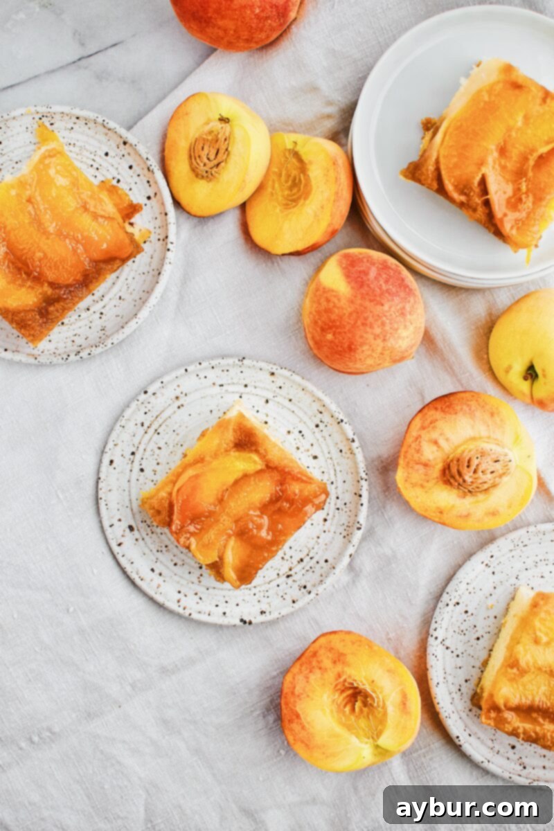 Full view of a Peach Upside-Down Cake in a square baking pan, showcasing the golden cake layer and the visible peach arrangement, ready to be inverted.