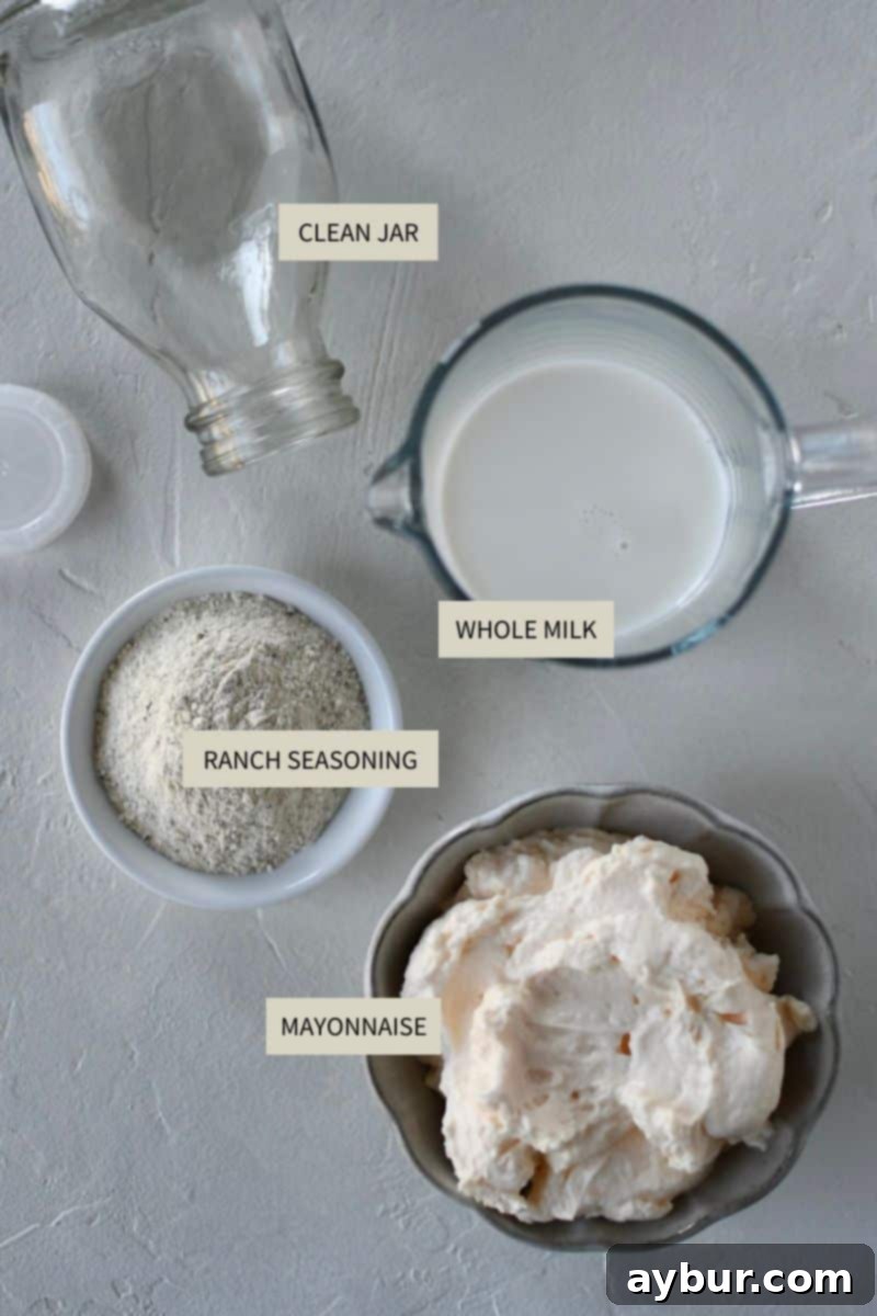 Three key ingredients displayed: a bottle of milk, a tub of mayonnaise, and a packet of ranch seasoning mix, on a wooden board.