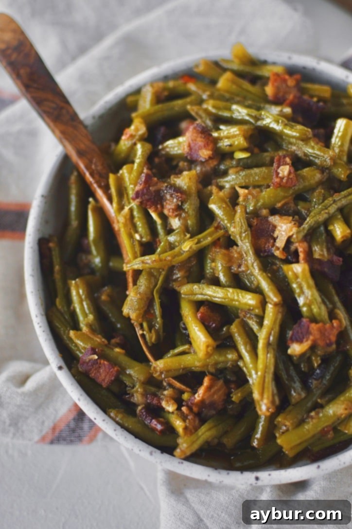 Southern Green Beans in a bowl with a spoon ready to be served.