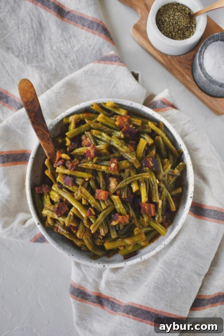 Southern Green Beans in a bowl with a spoon ready to be served.