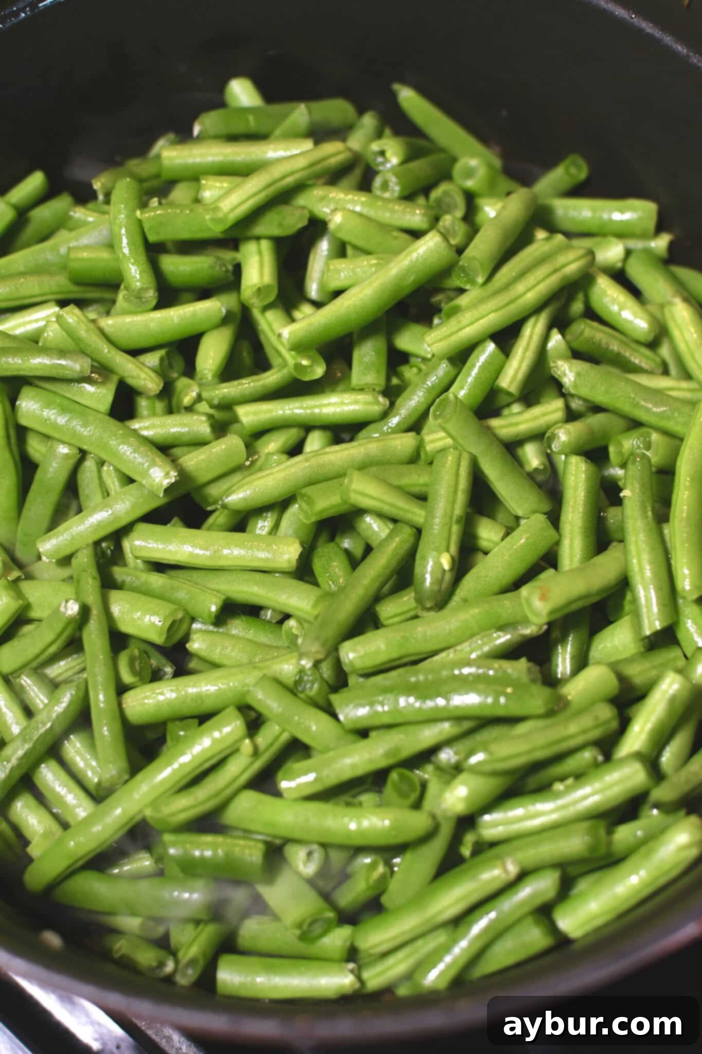 Trimmed green beans added to the pot.