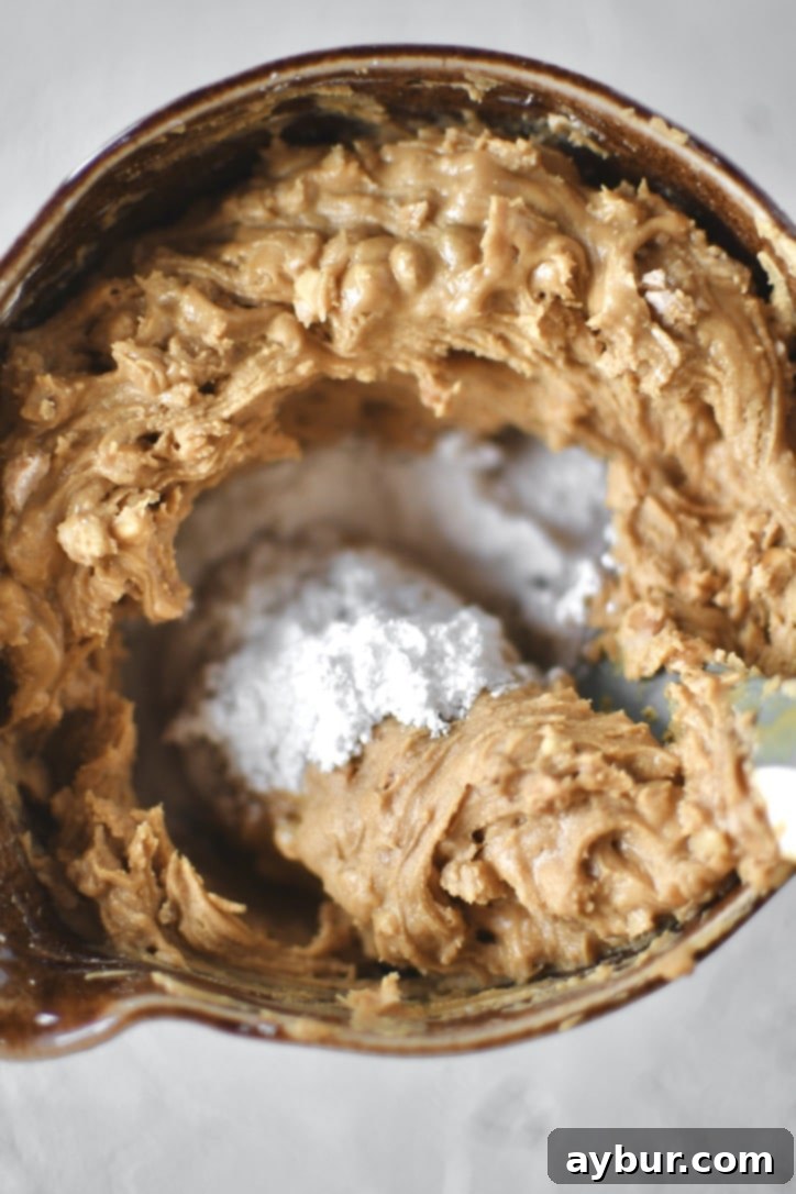 making the peanut butter filling by mixing the powdered sugar into the peanut butter.
