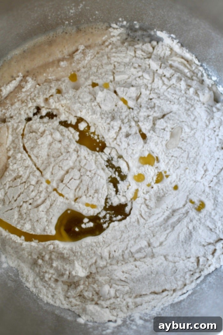 Perfect Homemade Calzone Dough 6 Flour and olive oil added to warm water and yeast.