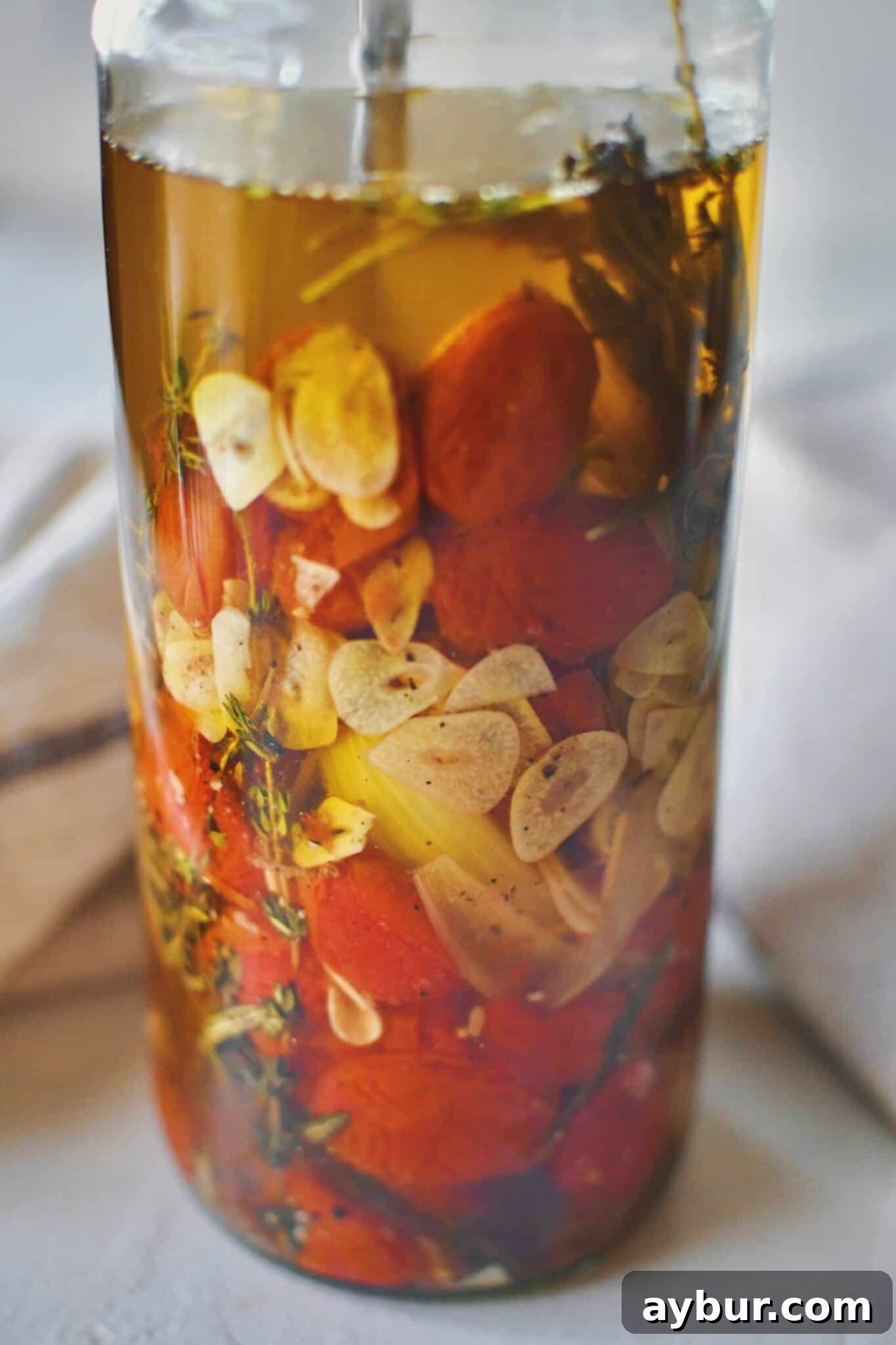 Slow-Roasted Tomato Confit 7 Tomato Confit in a jar covered in oil, ready to be stored.