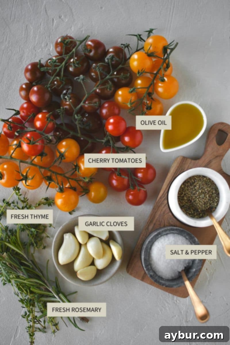 Fresh ingredients laid out for making roasted cherry tomatoes: cherry tomatoes on the vine, garlic, rosemary, thyme, olive oil, salt, and pepper.