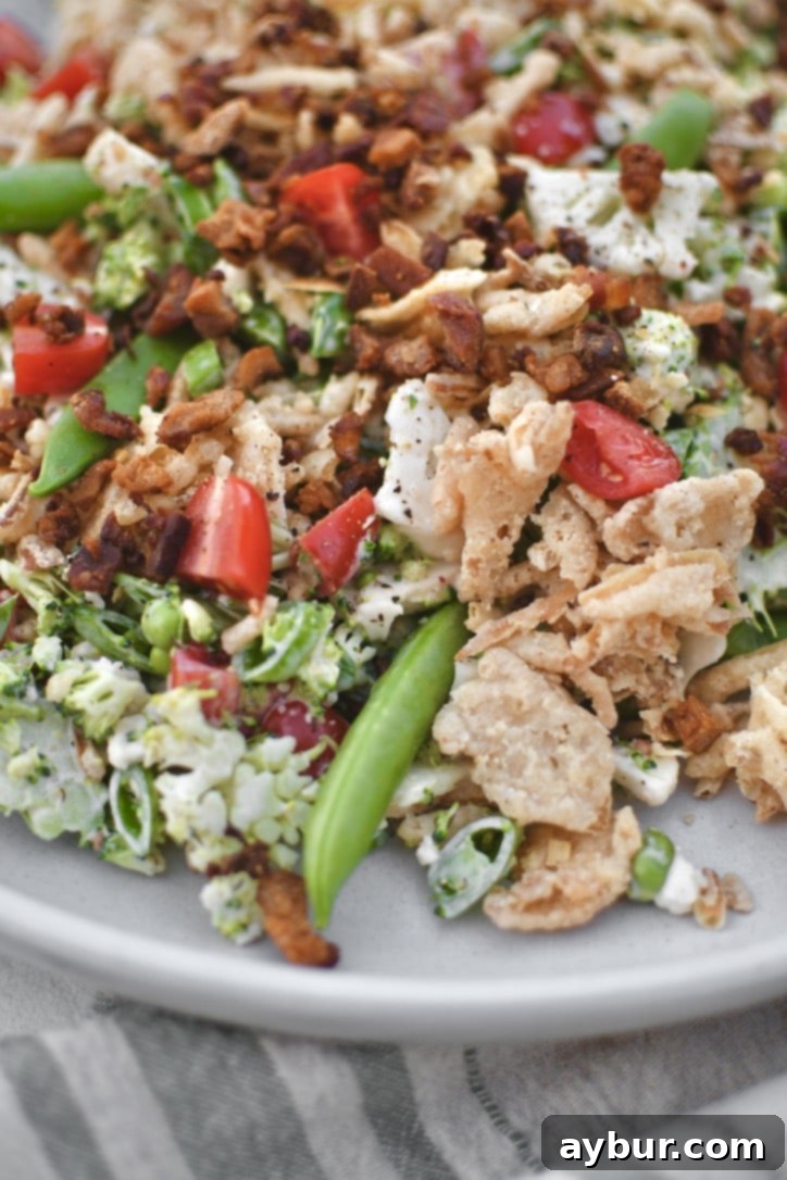 Crisp Snap Pea Salad 2 Vibrant Snap Pea Salad on a serving platter, generously topped with golden crispy onions and savory bacon bits, ready to be enjoyed.