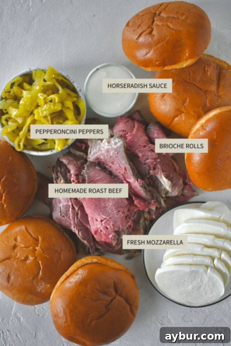 A flat lay of all the fresh and high-quality ingredients required to make the ultimate Roast Beef Sandwich, neatly arranged on a counter.