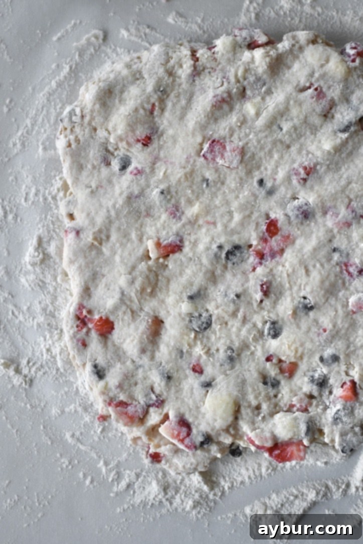 Scone dough flattened to an even thickness on a floured surface, ready for cutting.