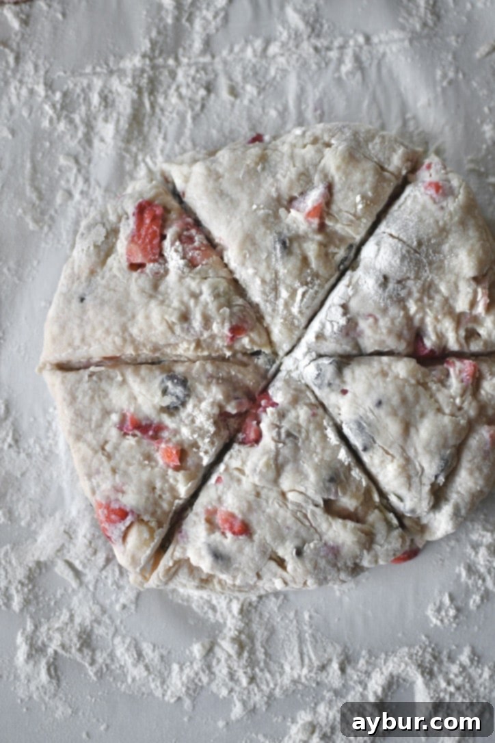 Alternatively, scone dough being cut into classic triangular wedges from a round disk.