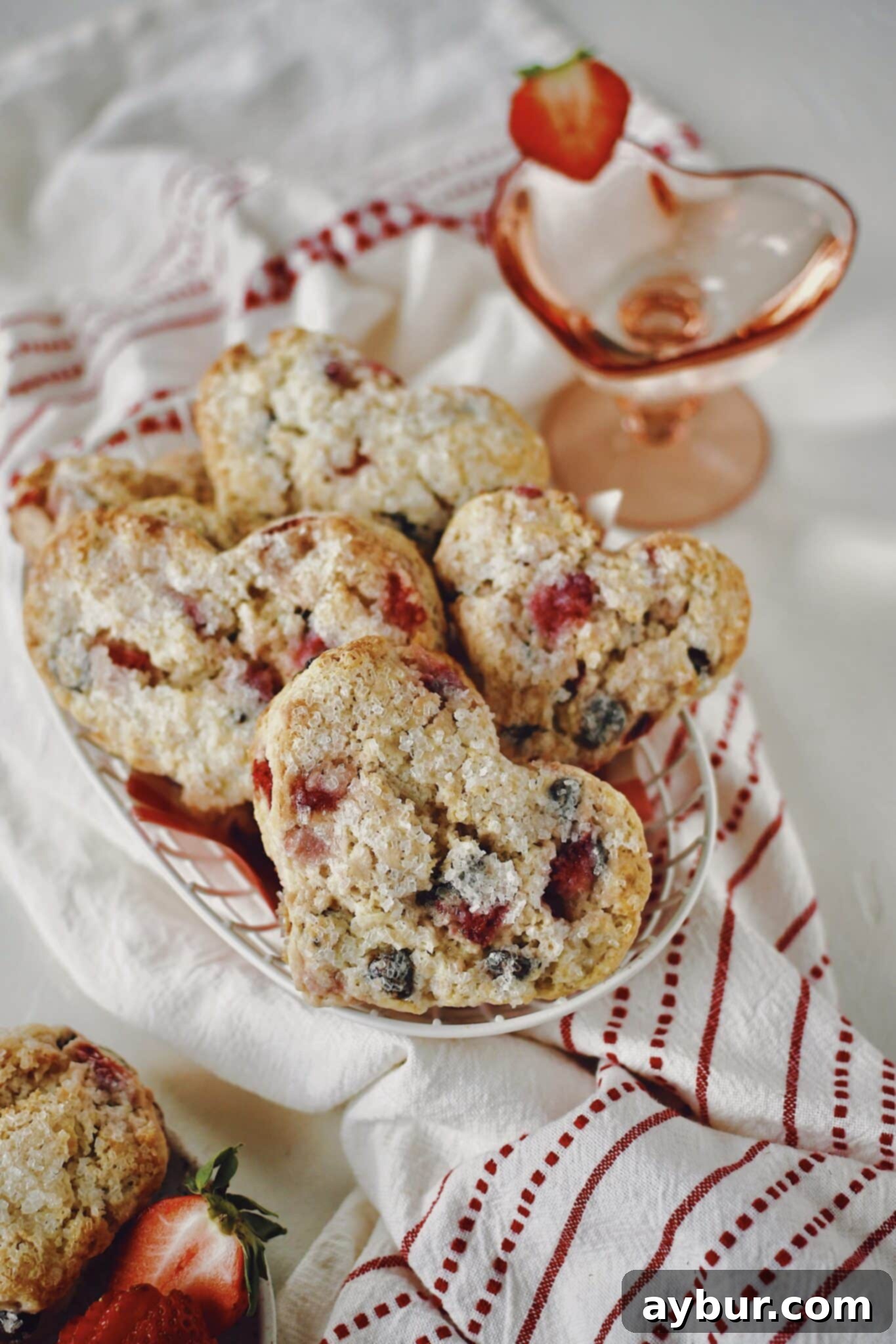 A charming basket filled with golden-brown, heart-shaped Strawberry Scones, ready to be served.