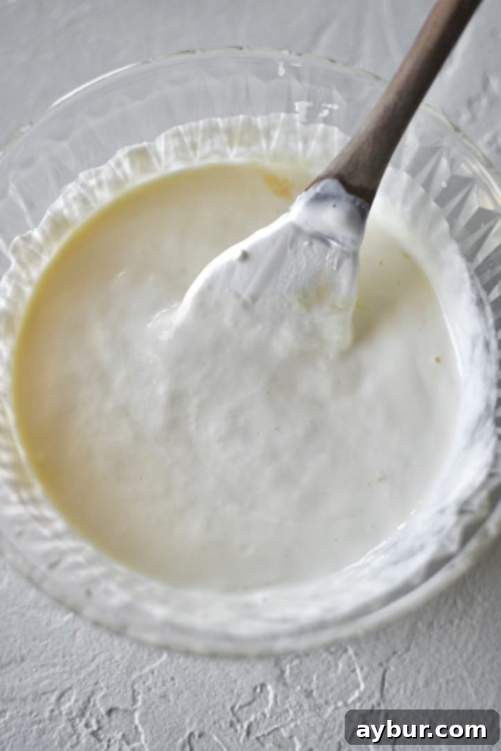 Egg and sour cream gently whisked together in a bowl, prepared for the scone dough.