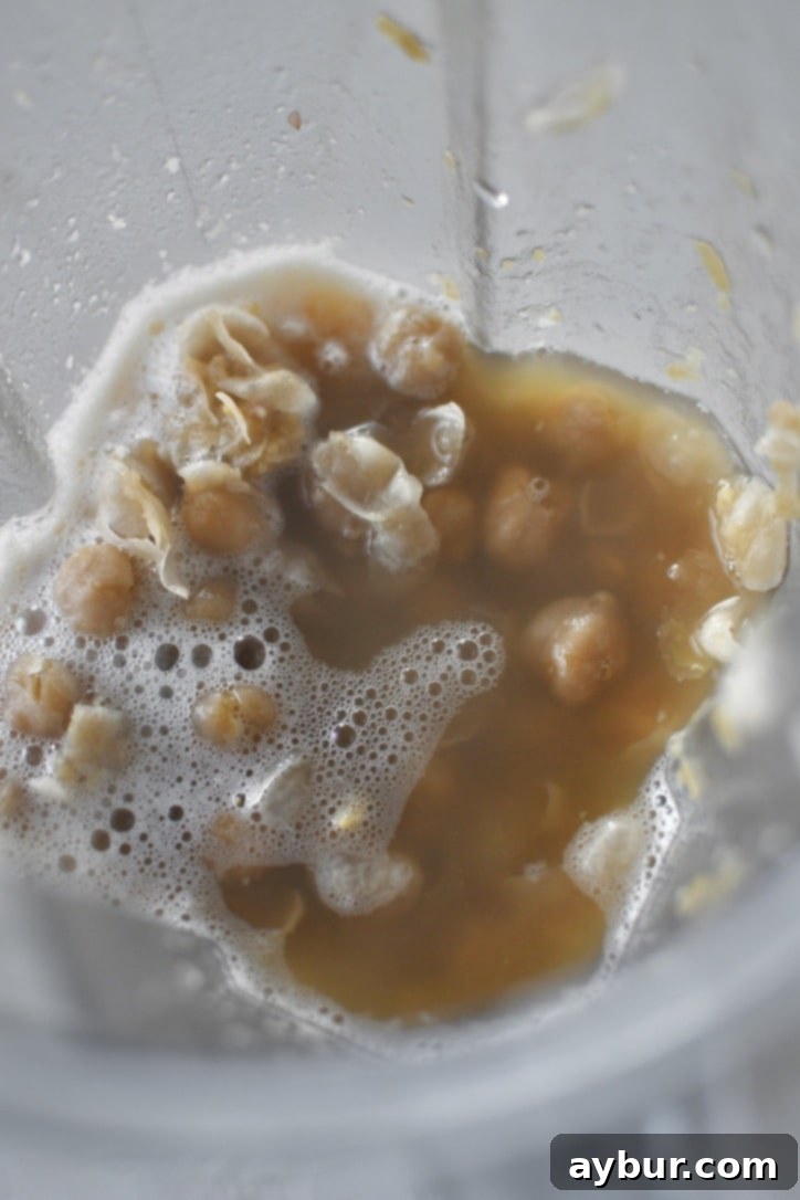 Creamy Homemade Hummus Perfection 6 Cooked chickpeas in a high speed blender with the cooking liquid ready to be pureed.