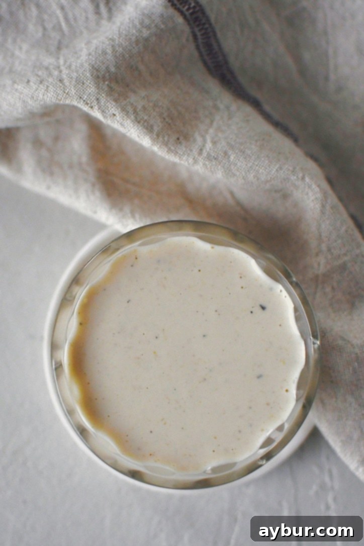 A close-up of the creamy horseradish sauce in a small bowl, highlighting its smooth texture and inviting color, ready for dipping or serving.