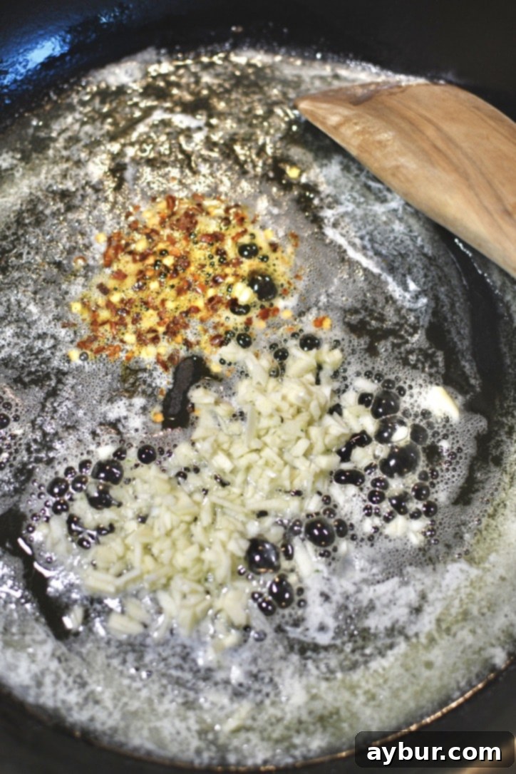 Starting the pasta sauce with melted butter and olive oil in a large pan with garlic and red pepper flakes.