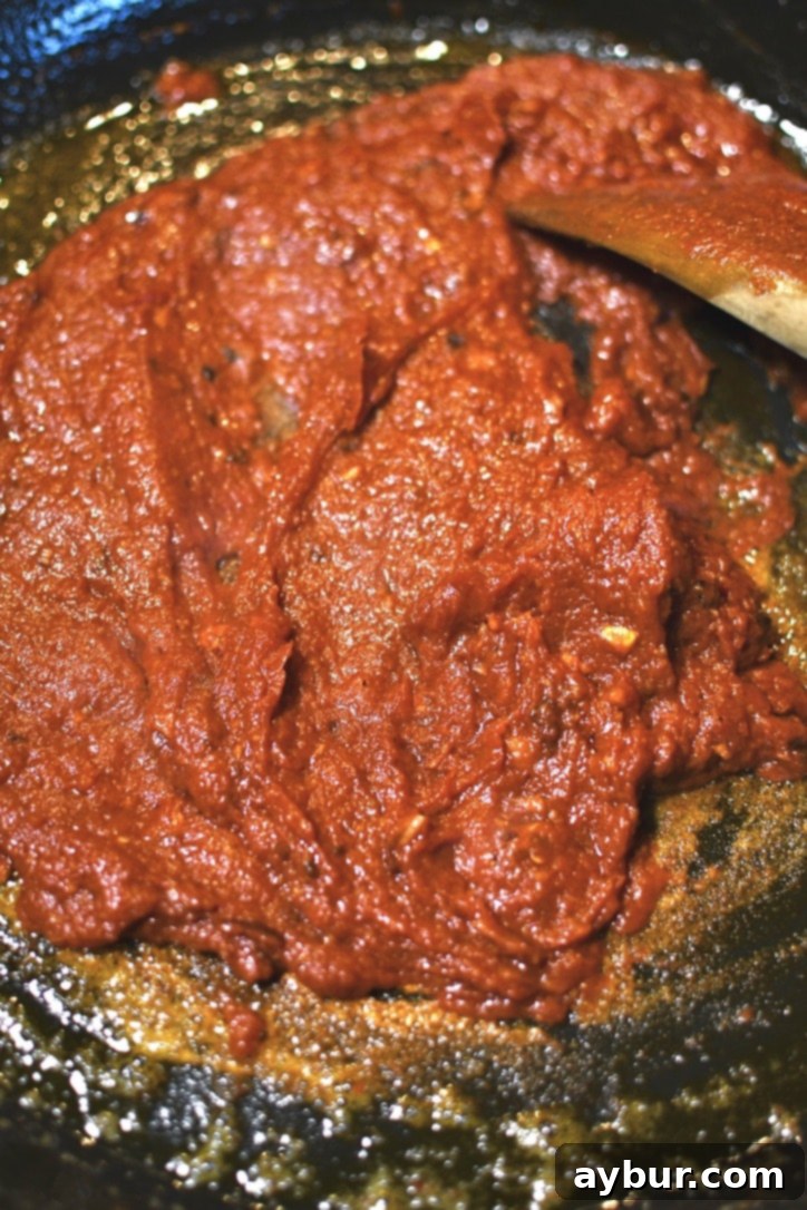 Cooked tomato and bouillon pastes in the pan till warmed through and aromatic.