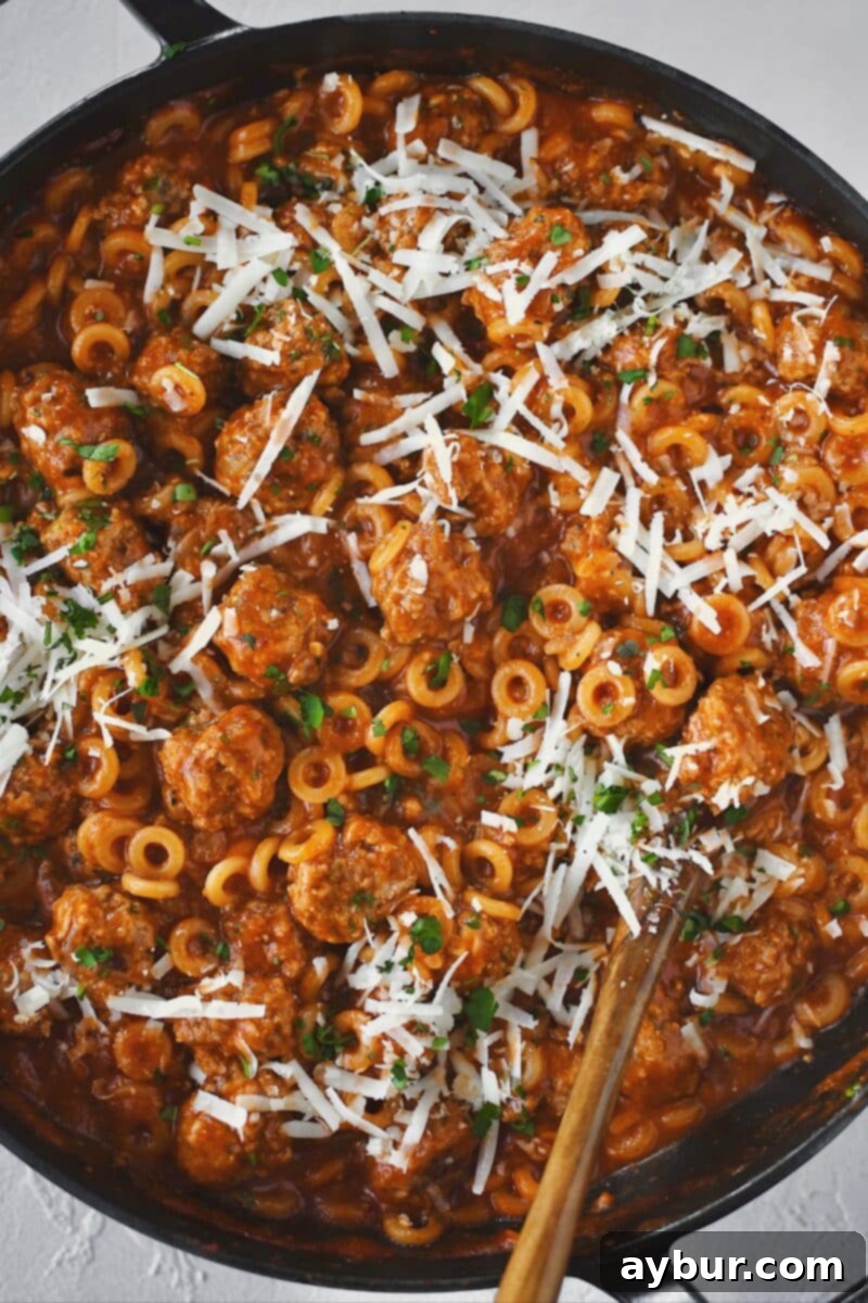 A close-up shot of Homemade Spaghettios with meatballs in a large pan, ready to be served.