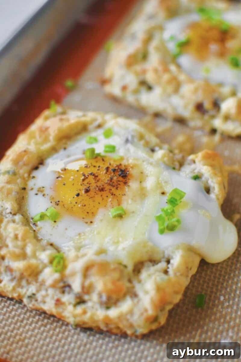 Sausage, Egg, and Cheese Biscuits just out of the oven and topped with chives.