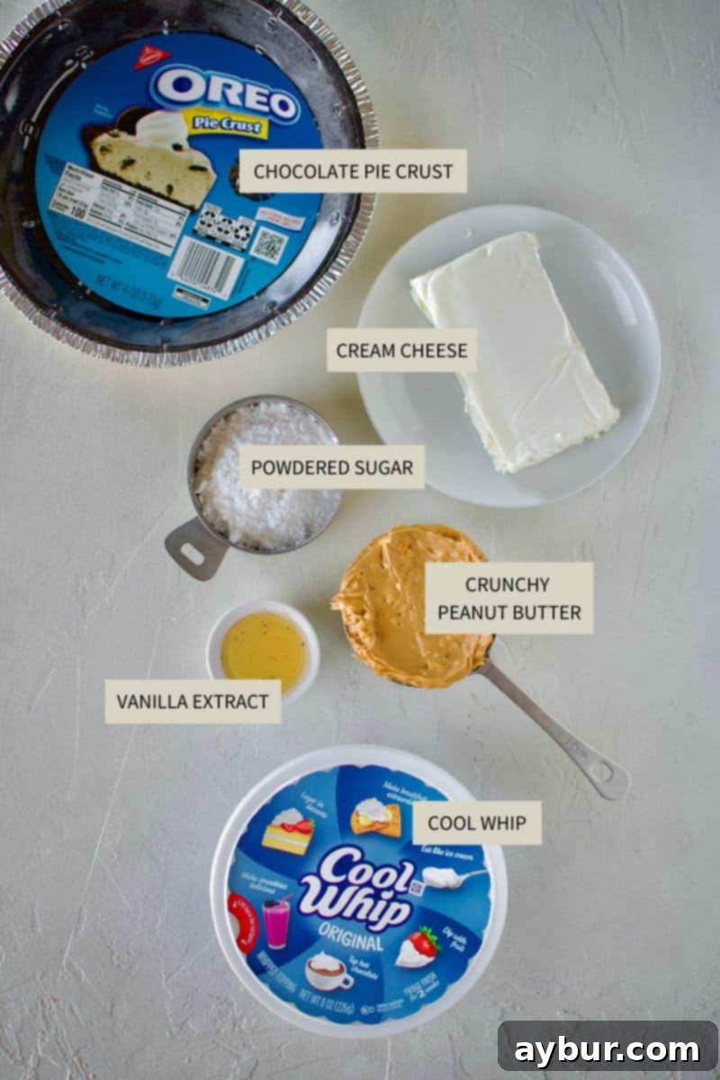 Peanut Butter Paradise Pie 3 A collection of ingredients laid out, ready to be used for making the No-Bake Peanut Butter Pie, including cream cheese, peanut butter, cool whip, and a pre-made chocolate crust.