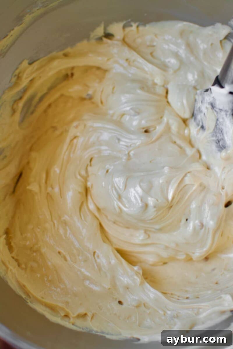 Peanut Butter Paradise Pie 6 Thawed Cool Whip gently folded into the peanut butter and cream cheese mixture, ensuring a light and airy consistency.