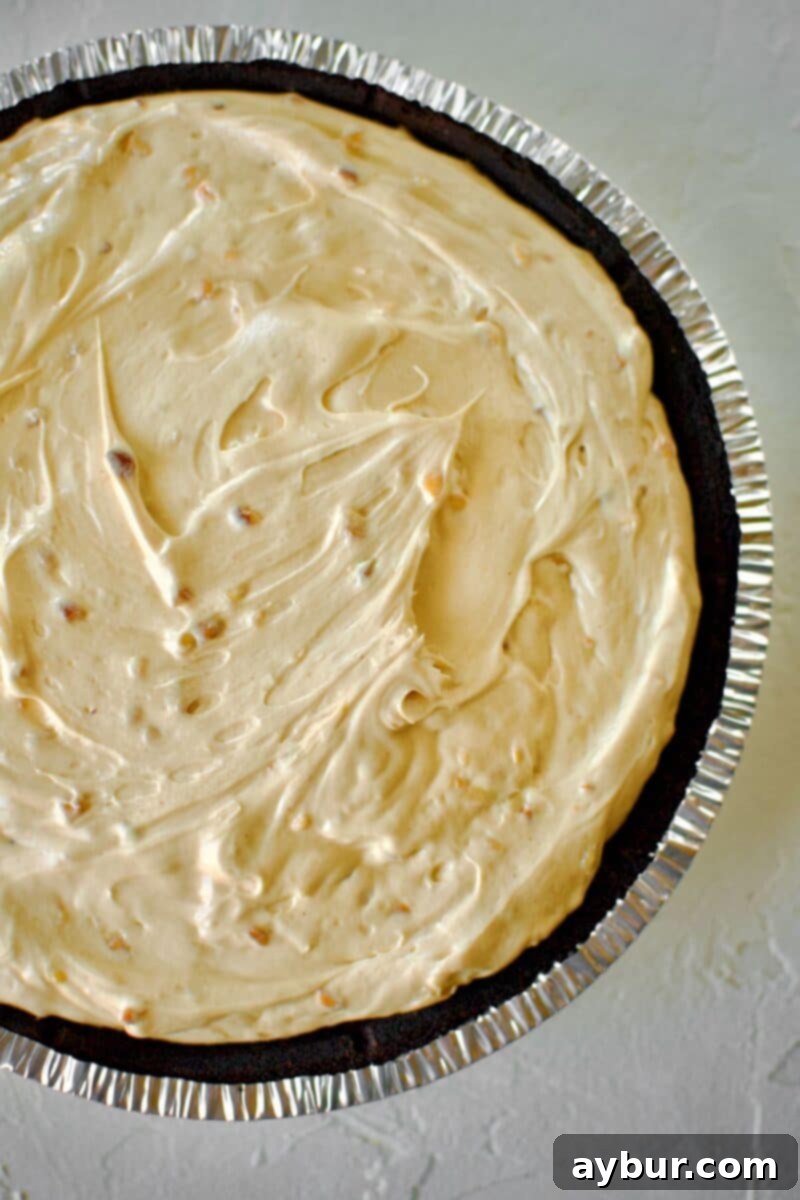 Peanut Butter Paradise Pie 7 The finished peanut butter filling smoothly added into the prepared chocolate pie crust, ready for chilling.