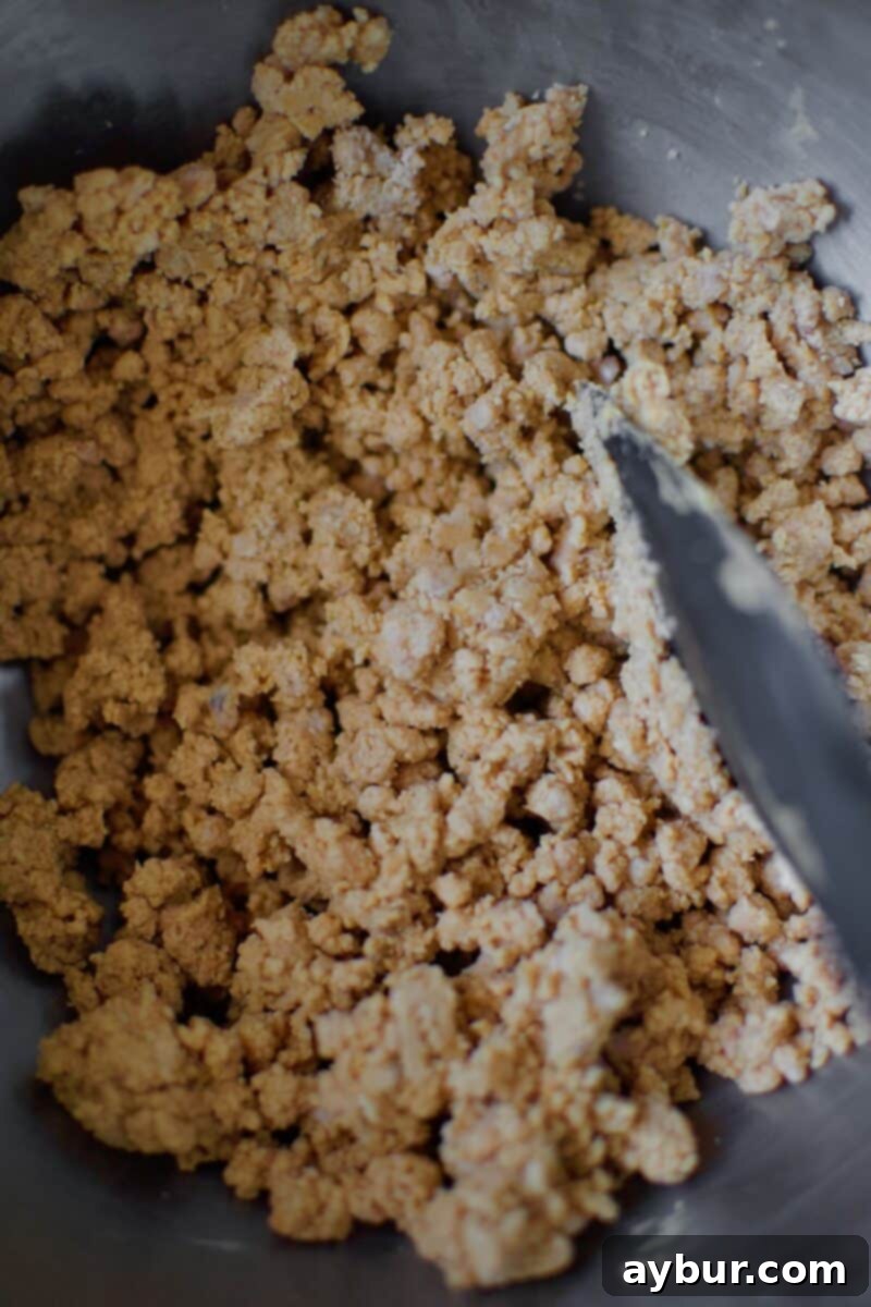 Peanut Butter Paradise Pie 9 The peanut butter crumble topping perfectly formed in the bowl of a stand mixer, showcasing its delicious texture.