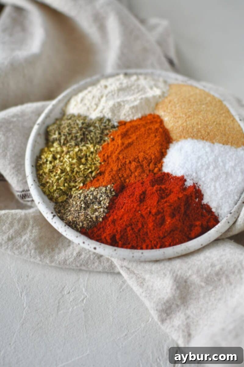 Ingredients for cajun seasoning laid out on a plate, ready to be combined.