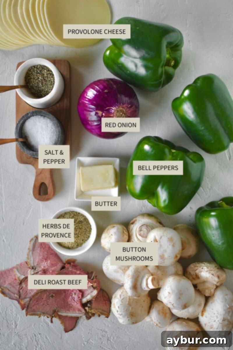 Stuffed Peppers with Philly Cheesesteak 3 Various ingredients laid out on a cutting board, ready to be used for making Philly Cheesesteak Stuffed Peppers.