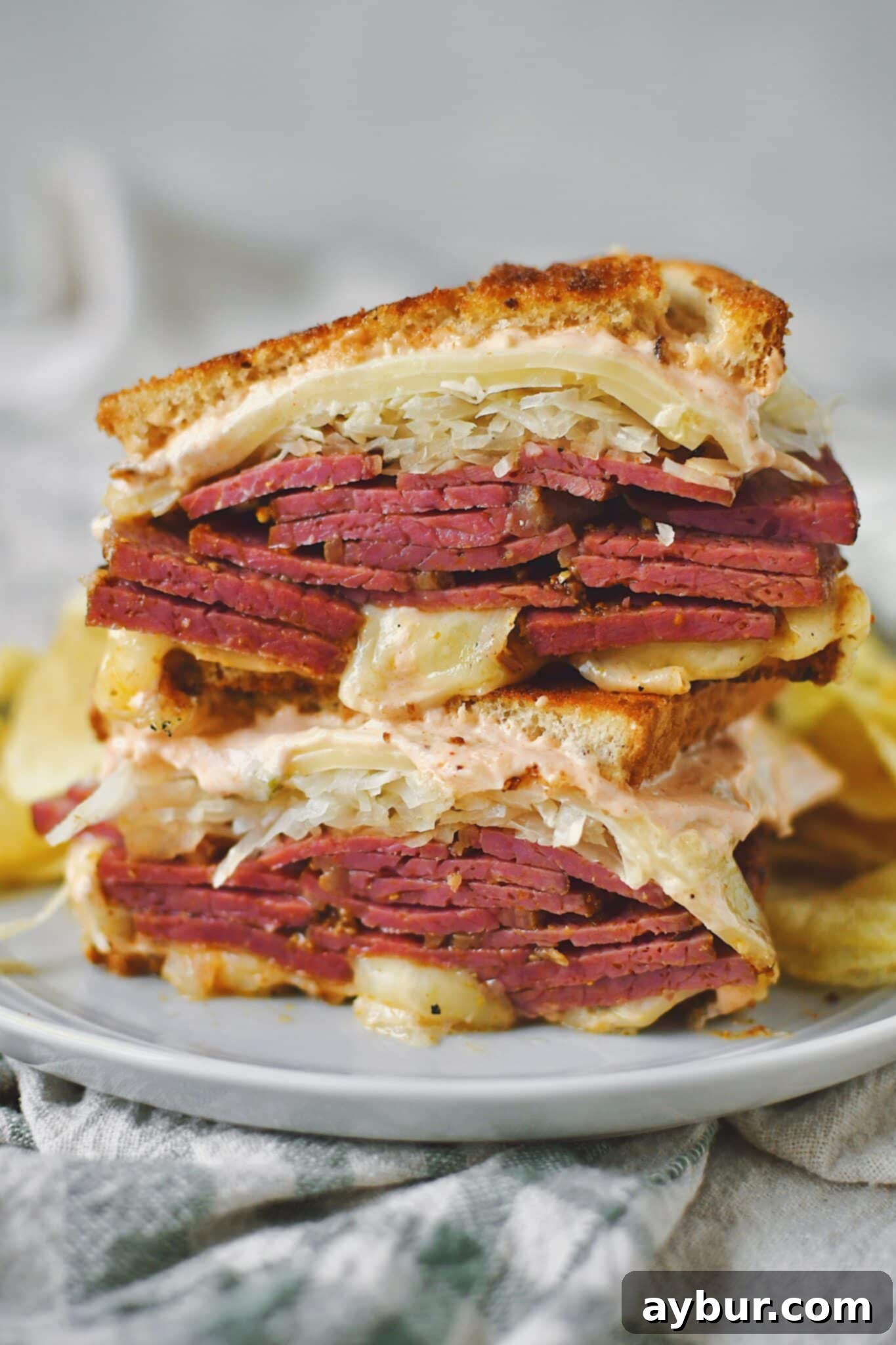 A mouthwatering Reuben sandwich made with freshly sliced homemade pastrami, sauerkraut, and Swiss cheese on toasted rye bread.