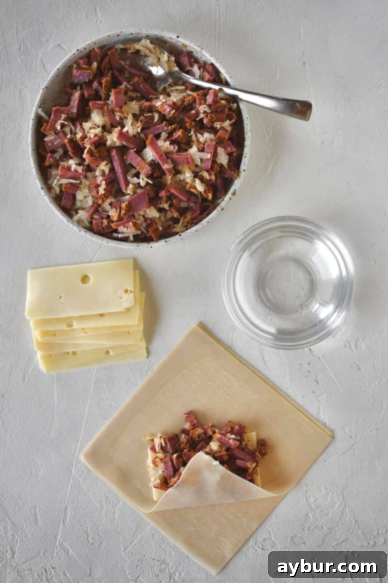 Beginning to fold an egg roll, folding up the bottom corner.