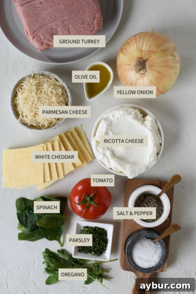 A selection of fresh ingredients including ground turkey, ricotta, parmesan, white cheddar, panko breadcrumbs, fresh herbs, and a diced onion, ready to be combined for the turkey burgers.