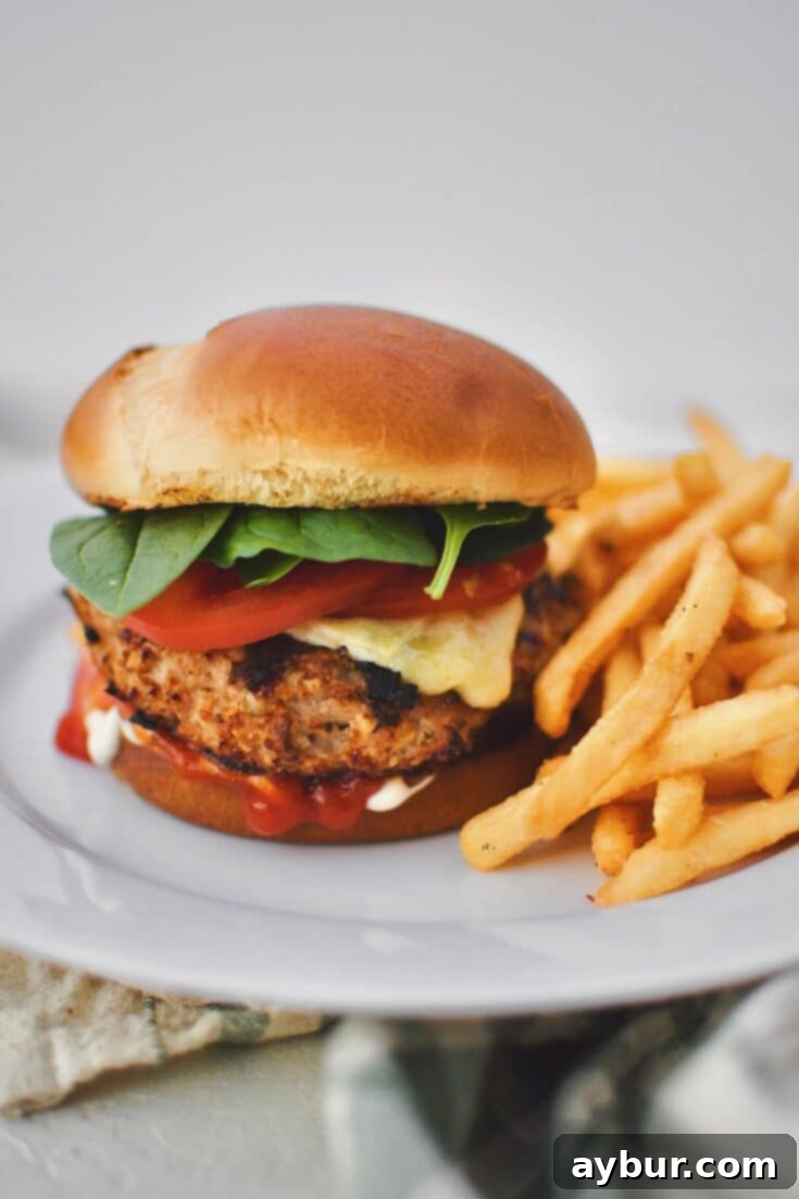 Assembled Turkey Burger on a plate with fries.