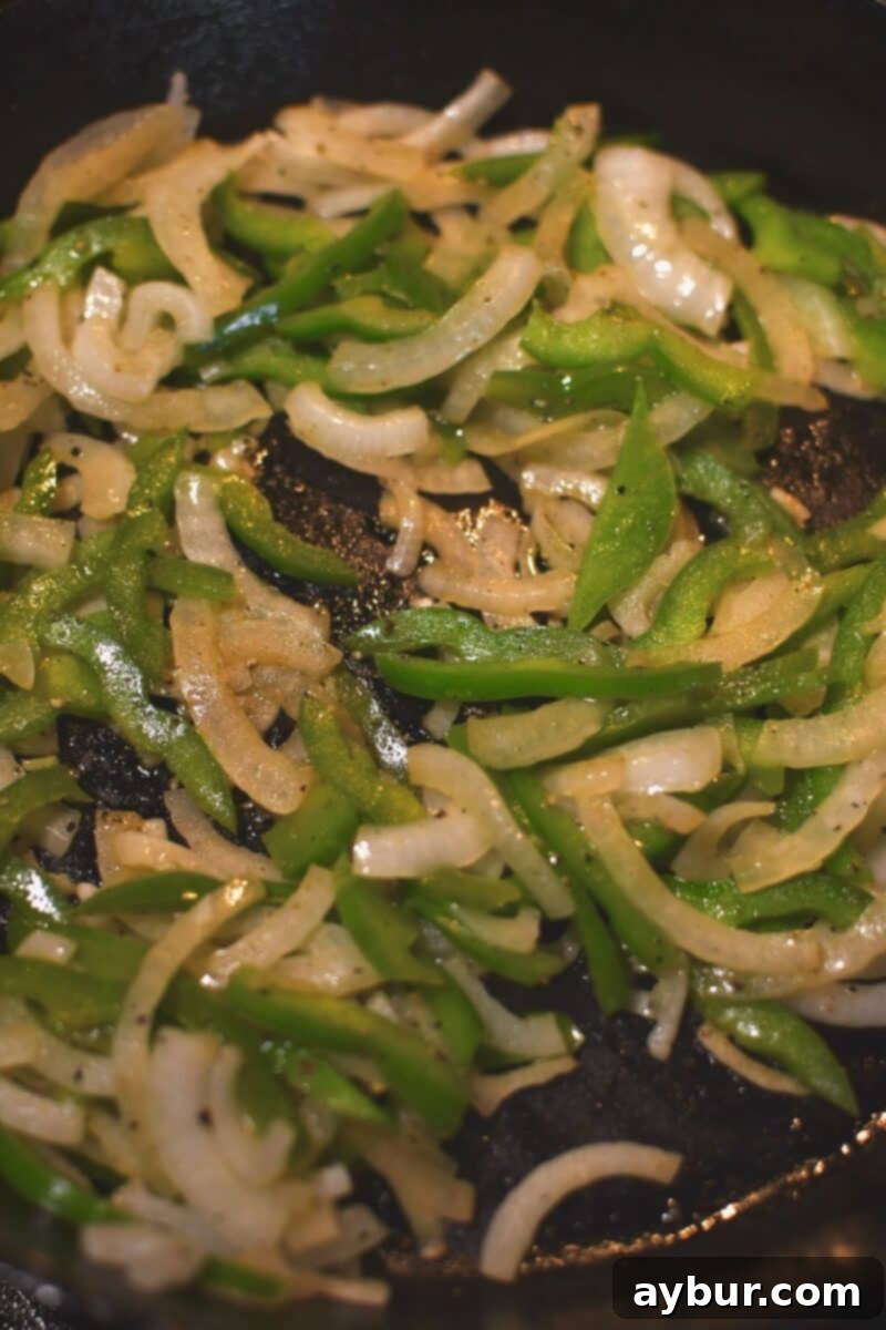 Sauteing the onions and bell peppers in some butter till soft.