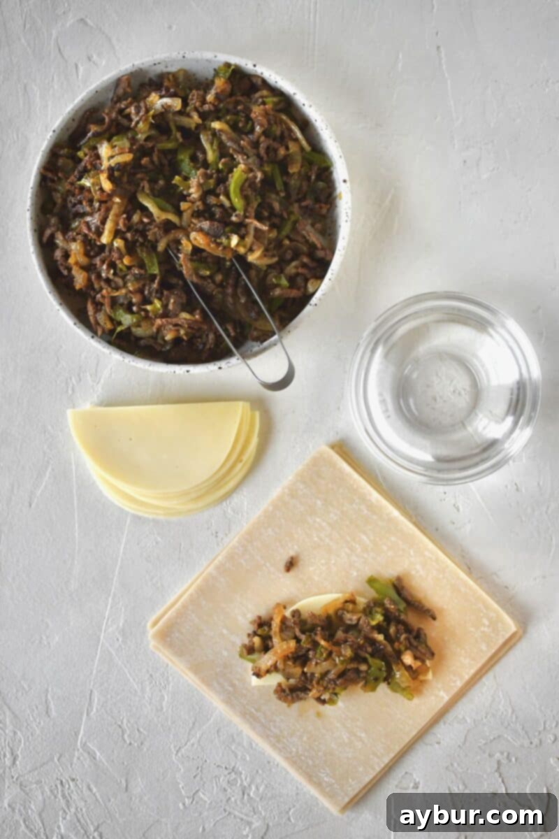 Adding the filling to an egg roll wrapper.