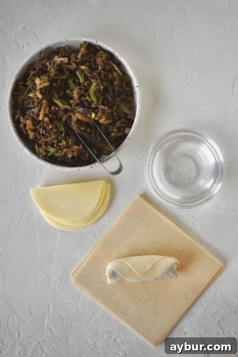 Fully rolled egg roll ready to fry until crisp.