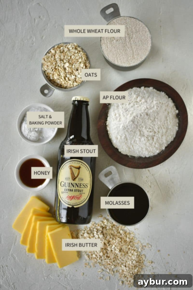 Traditional Irish Brown Bread 3 A selection of fresh ingredients laid out on a countertop, including flours, oats, Guinness, honey, molasses, and Irish butter, all ready to be used for making Irish Brown Bread.