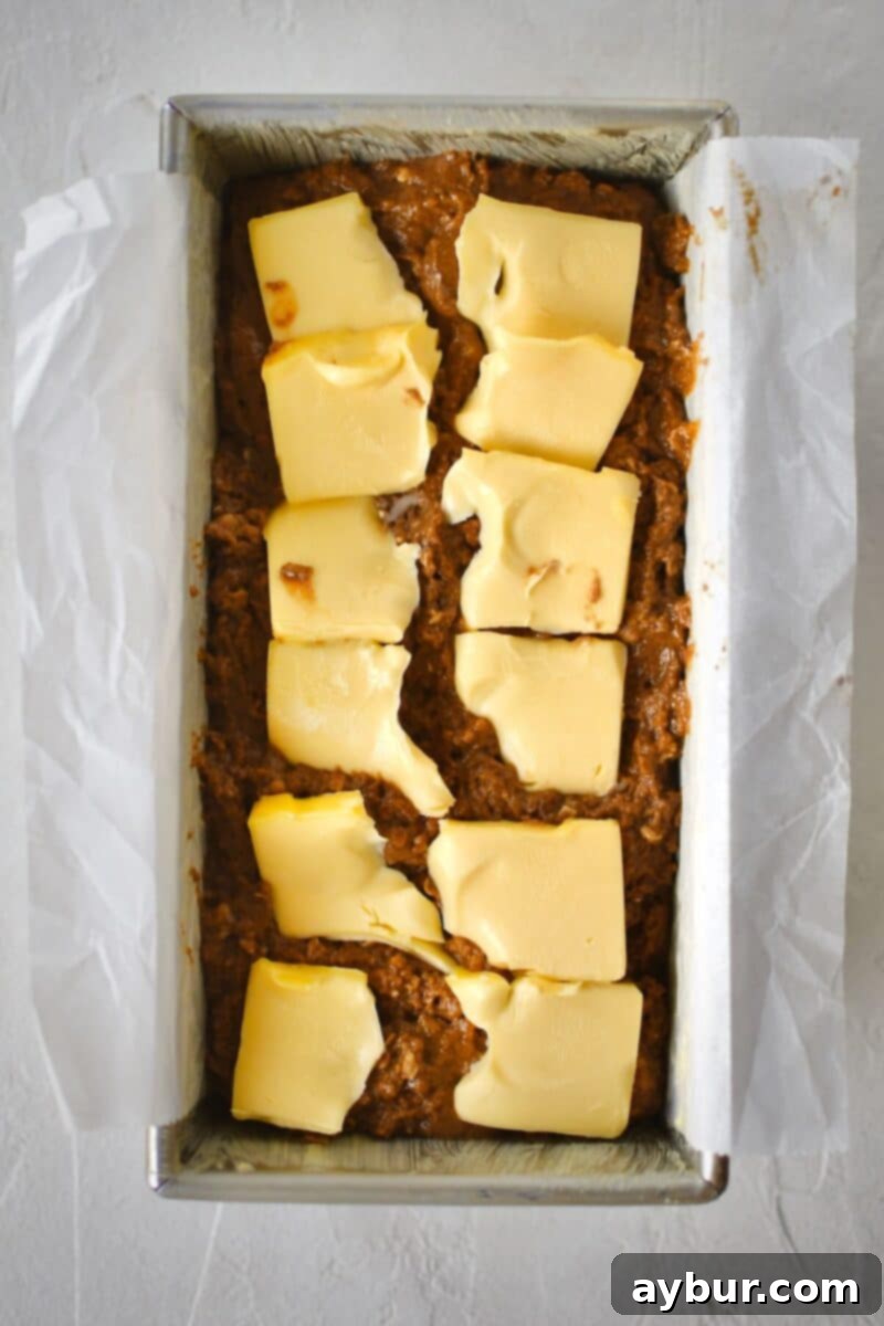 Traditional Irish Brown Bread 9 Thin slices of butter are carefully placed on top of the unbaked brown bread dough in the loaf pan.