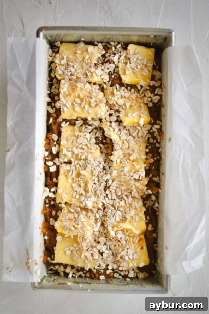 Traditional Irish Brown Bread 10 The unbaked bread dough in the loaf pan is topped with both butter slices and a scattering of oats before going into the oven.