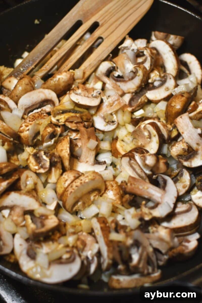 Creamy Chicken Stroganoff 6 Sautéing mushrooms, onions, and garlic in butter for the stroganoff sauce.