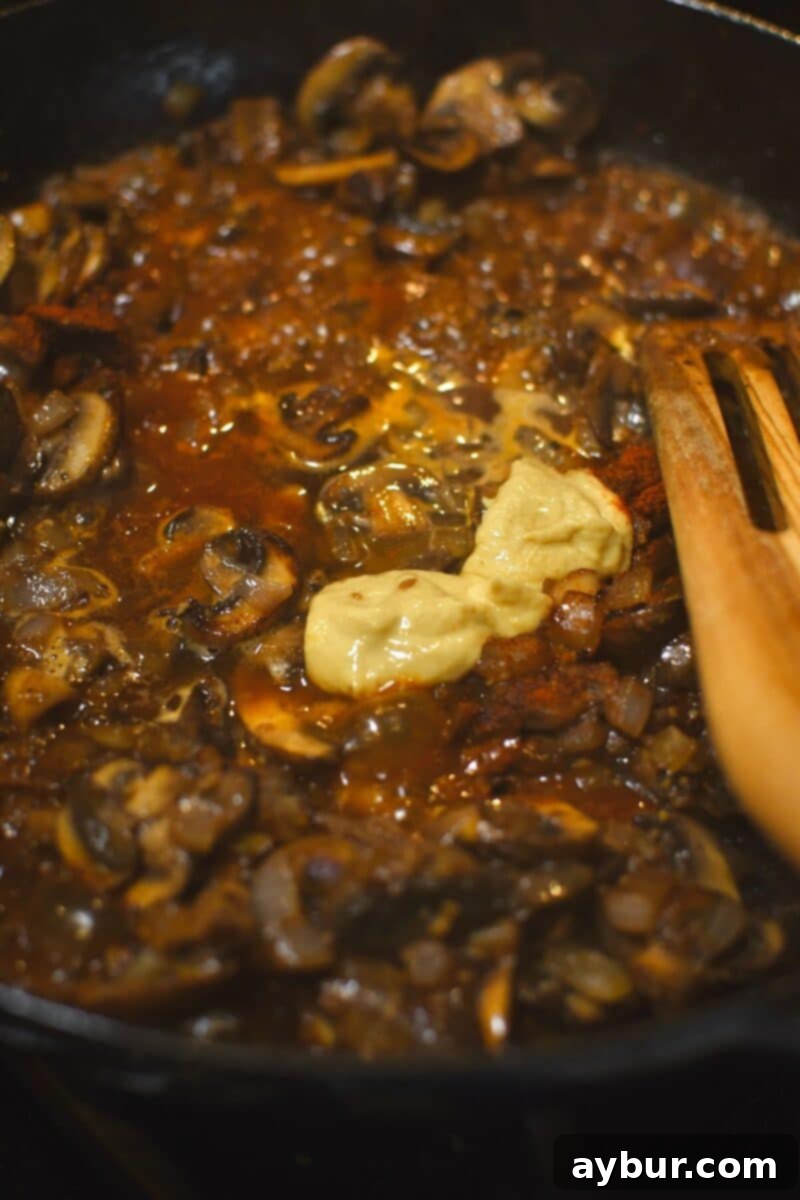 Creamy Chicken Stroganoff 9 Deglazing the pan with white wine and Dijon mustard for the stroganoff sauce.